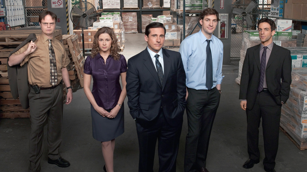 Image of "The Office" cast, showcasing Michael Scott, Jim Halpert, Pam Beesly, and Dwight Schrute at Dunder Mifflin.