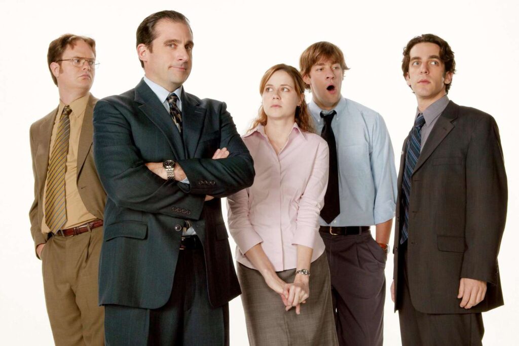 Image of "The Office" cast, showcasing Michael Scott, Jim Halpert, Pam Beesly, and Dwight Schrute at Dunder Mifflin.